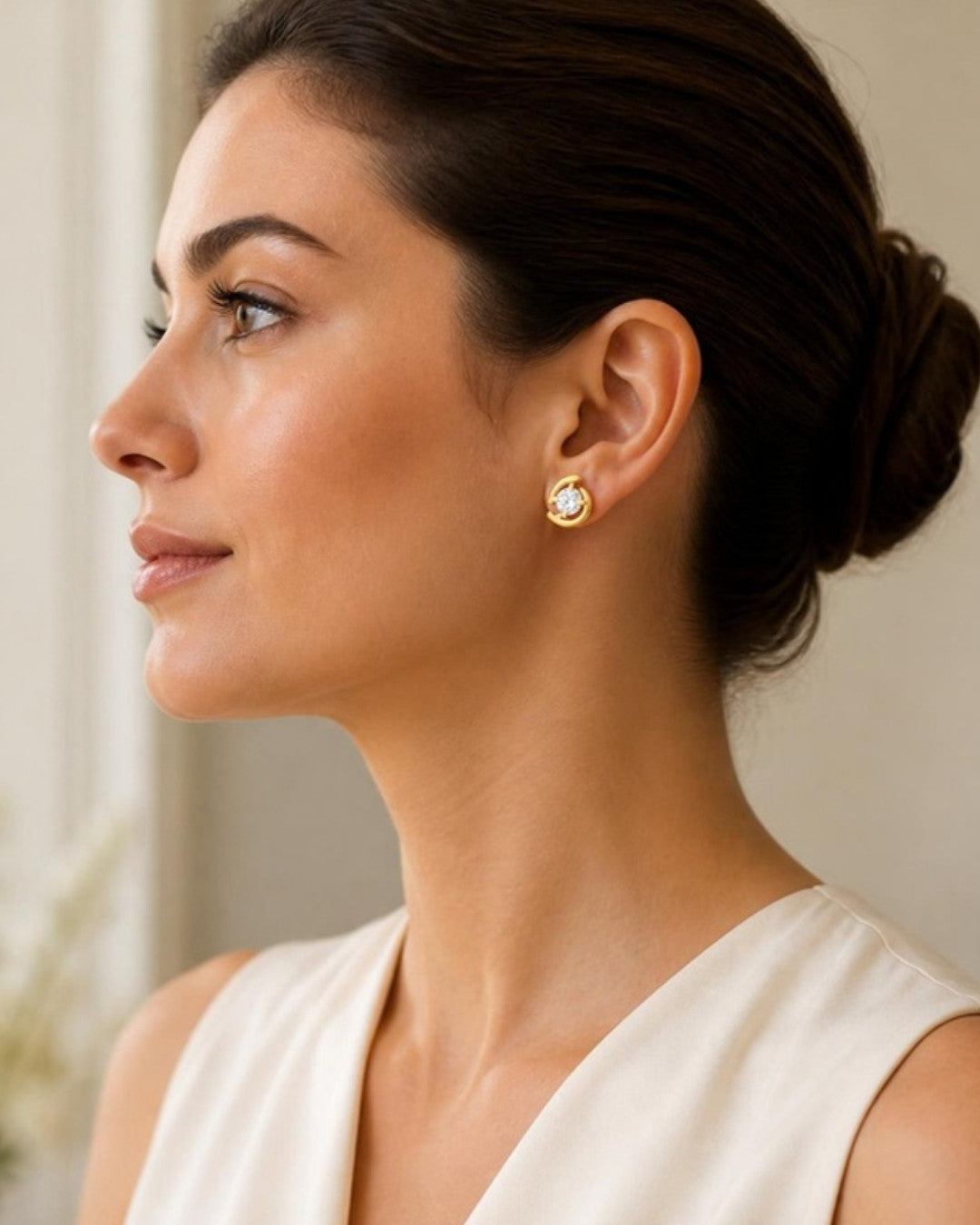 Woman wearing Aurora Gold Embrace Stud Earrings, side profile view