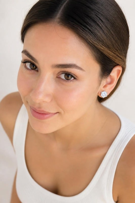 Celestial Crown Hexa Solitaire Stud Earrings worn by a model, top-down view