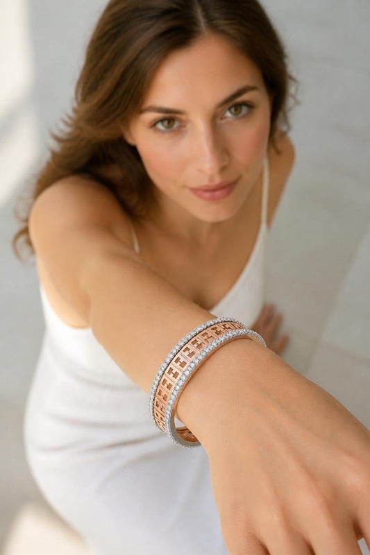 Sanskriti Geometric Diamond-Edge Gold Bracelet worn by a model, top-down view