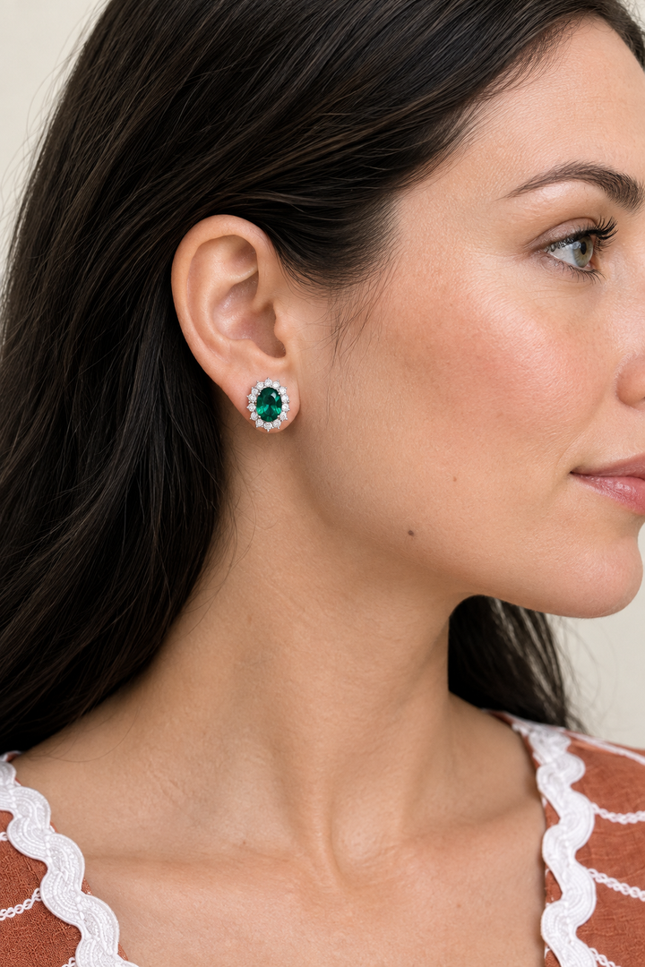 Model wearing an emerald halo stud earring, side view